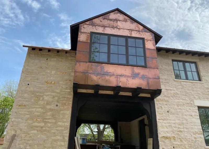 Copper metal panel facade on a stone building for Skylight Installation in Oak Hills